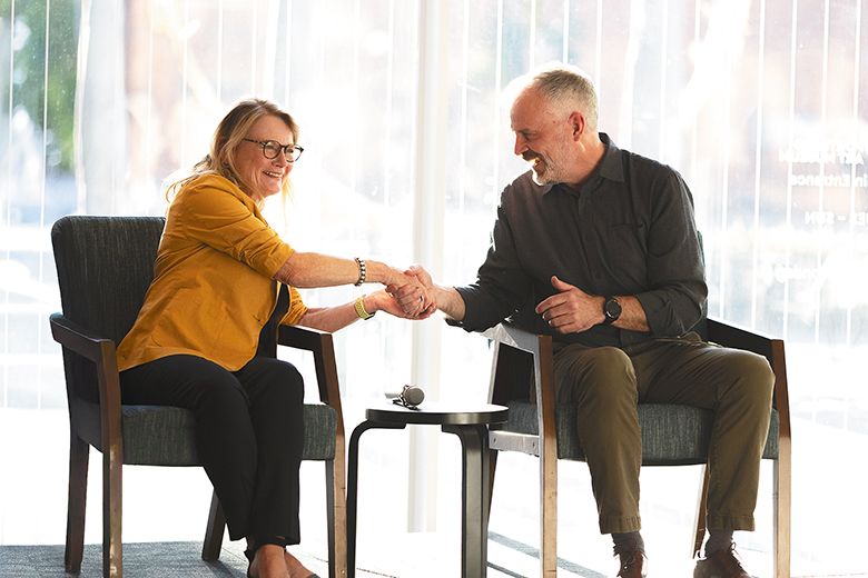 Painter Hazel Schlesinger (right) shaking hands with Tresider Burns, Alexana Estate&rsquo;s winemaker.  ## Photo By Kitta Bodmer