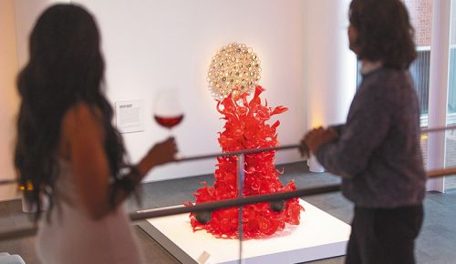 Two women admiring art while drinking wine at the museum. ## Photo By Kitta Bodmer