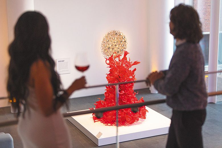 Two women admiring art while drinking wine at the museum. ## Photo By Kitta Bodmer