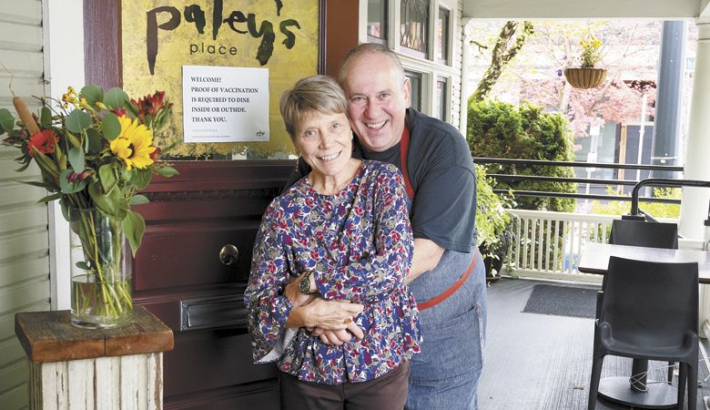 Vitaly and Kimberly on the porch at Paley’s Place donning masks and continuing stellar service. ##Photo by Andrea Johnson