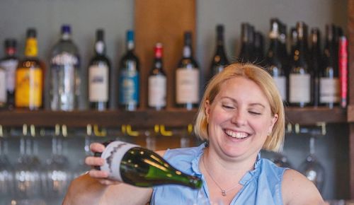 Sommelier Stacey Gibson pouring a glass of sparkling wine. ## Photo by Josh Chang/Foundry 503