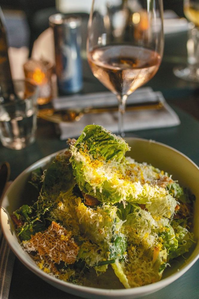 Parallel’s signature salad is an umami-rich riff on a Caesar with lemon anchovy vinaigrette topped with a shaven Worcestershire-cured egg yolk.  ## Photo by Josh Chang/Foundry 503