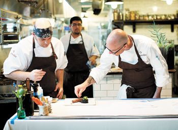 Executive chef Daniel Mondok puts
the finishing touches on a dish at the newly opened Paulée in Dundee. Photo by John Valls