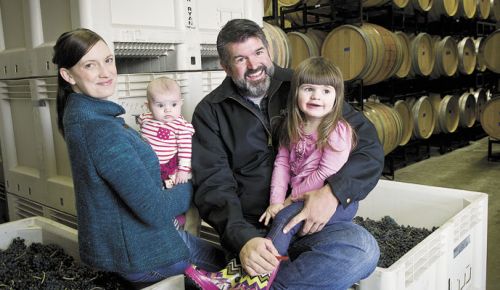 Megan and Mark McNeilly inside the couple’s Woodinville winery, Mark Ryan, with their daughters in tow. ##Photo by Andrea Johnson