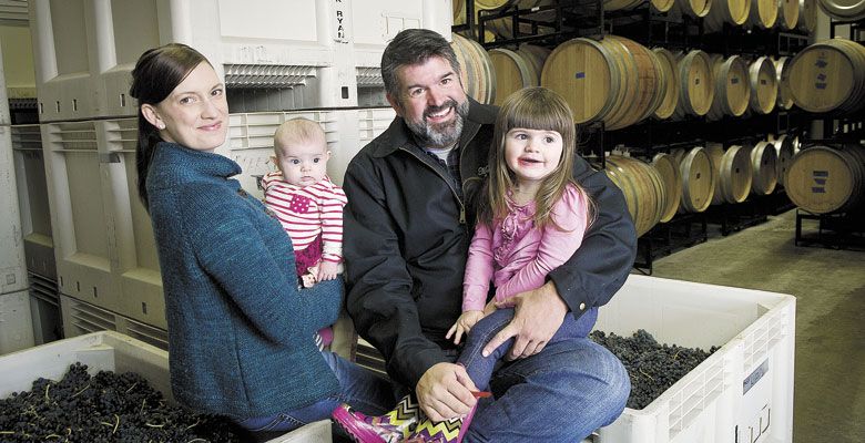 Megan and Mark McNeilly inside the couple’s Woodinville winery, Mark Ryan, with their daughters in tow. ##Photo by Andrea Johnson