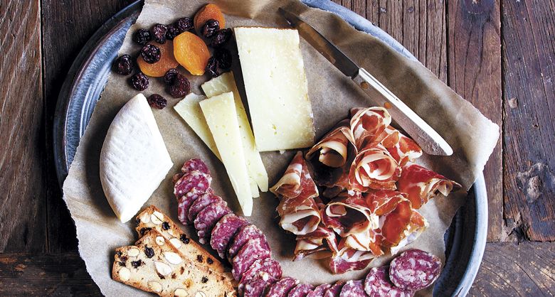 Slices of fennel salami, from Chop in Portland, and coppa rosettes, from The Beautiful Pig in Longview, Washington, accompany six-month aged Manchego and sheep’s milk Robiola. ##Photo by Christine Hyatt