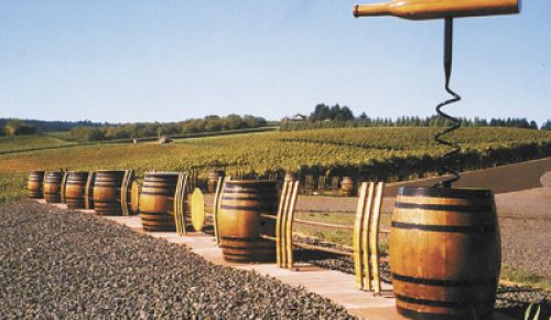 Wine barrels, a massive cork screw and barrel staves create a dramatic fence line adjacent to Sims Estate Vineyard at Barrel Fence Cellars in Dundee.