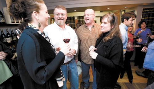 Jody and John Wrigley (left) of J Wrigley and Henry and Cathy Pollack of Noble Pig
share a moment during the open house at their new tasting room in Carlton. Photo by Marcus Larson.