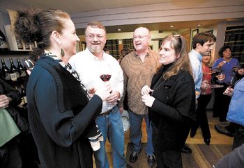 Jody and John Wrigley (left) of J Wrigley and Henry and Cathy Pollack of Noble Pig
share a moment during the open house at their new tasting room in Carlton. Photo by Marcus Larson.