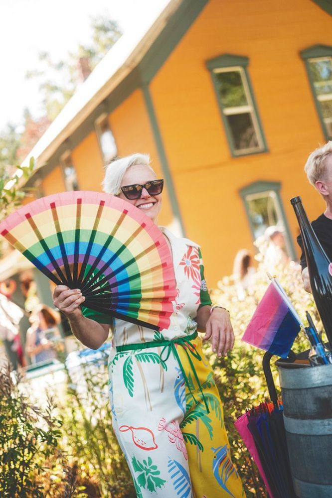 Remy Drabkin, Remy Wines&rsquo; founder and winemaker, holding a rainbow fan. ## Photo by Cheryl Juetten