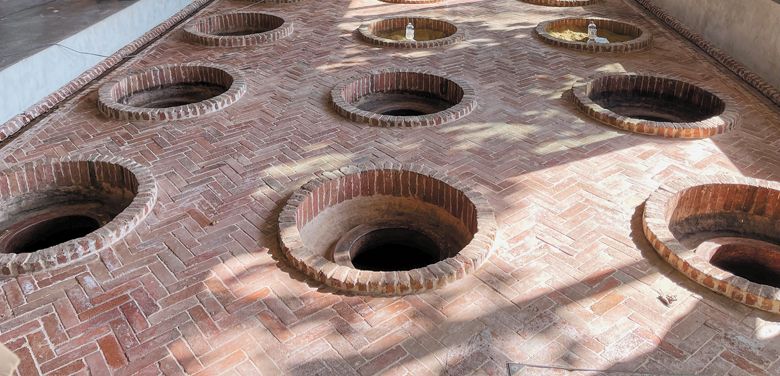 Qvevri buried in the ground at Mukhrani Castle.  This is the traditional way of making wine.  Pouring the tanks ensures even temperatures during the winemaking process.##Photo by Neal d.  Hulkower