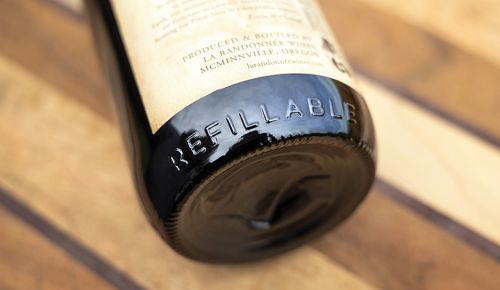 All Revino bottles are embossed with the word “refillable” circling the bottom. ## Photo by Rachel Thompson