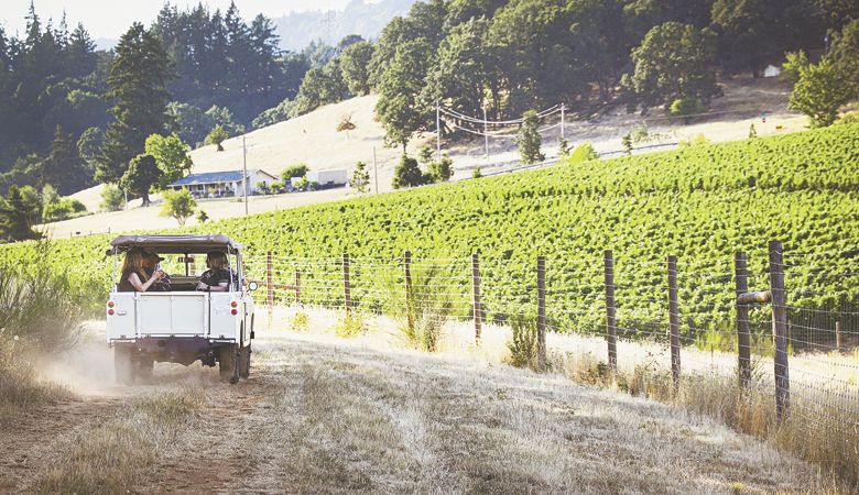 Guests enjoy a ride in the classic 1969 Land Rover at Rain Dance Vineyards in Newberg.##Photo courtesy of Travel Newberg