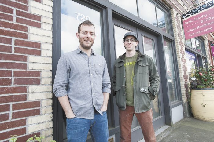 Kyle Lattimer (left) and Paul Losch stand in front of the Newberg building that will house Ruddick/Wood, set to open this summer.