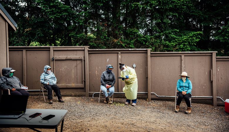 Miriam Lopez, ¡Salud! clinical outreach team assistant, gathers necessary medical information from a vineyard worker attending the mobile clinic at Willakenzie Estate outside Yamhill. ##Photo by Kathryn Elsesser