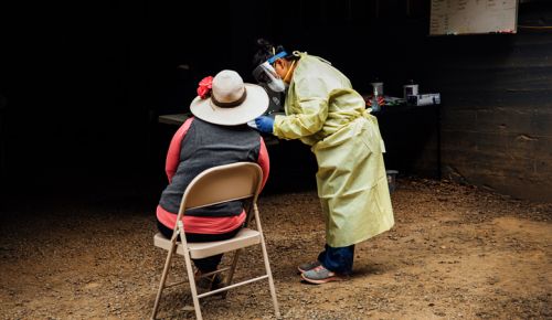 Miriam Lopez, ¡Salud! clinical outreach team assistant, gathers necessary medical information from a vineyard worker attending the mobile clinic at Willakenzie Estate outside Yamhill. ##Photo by Kathryn Elsesser