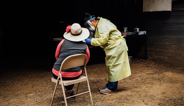Miriam Lopez, ¡Salud! clinical outreach team assistant, gathers necessary medical information from a vineyard worker attending the mobile clinic at Willakenzie Estate outside Yamhill. ##Photo by Kathryn Elsesser