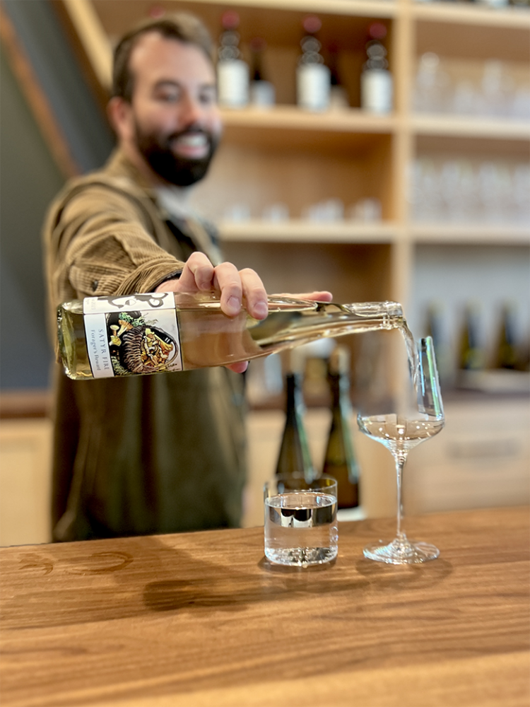 Owner and winemaker Paul Johnson pouring a sample of white wine. ## Photo provided by Satyr Fire
