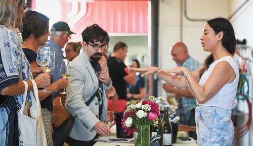 Kate Norris, co-owner & co-winemaker of Division Winemaking Company, pouring her Sauvignon Blanc wines for enthusiasts of the variety. ##Photo provided by Durant Vineyards