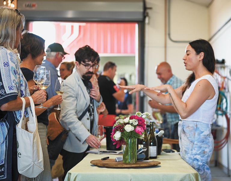 Kate Norris, co-owner & co-winemaker of Division Winemaking Company, pouring her Sauvignon Blanc wines for enthusiasts of the variety. ##Photo provided by Durant Vineyards