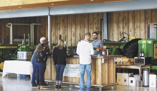 Winemaker Gabriel Jagle pours Scenic Valley wines at the tasting room filled with retired tractors and cool vintage cars. ##Photo by Viki Eierdam