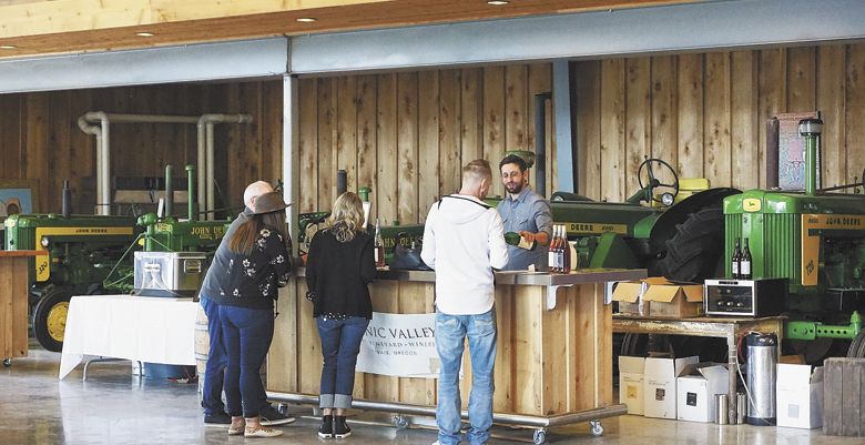 Winemaker Gabriel Jagle pours Scenic Valley wines at the tasting room filled with retired tractors and cool vintage cars. ##Photo by Viki Eierdam