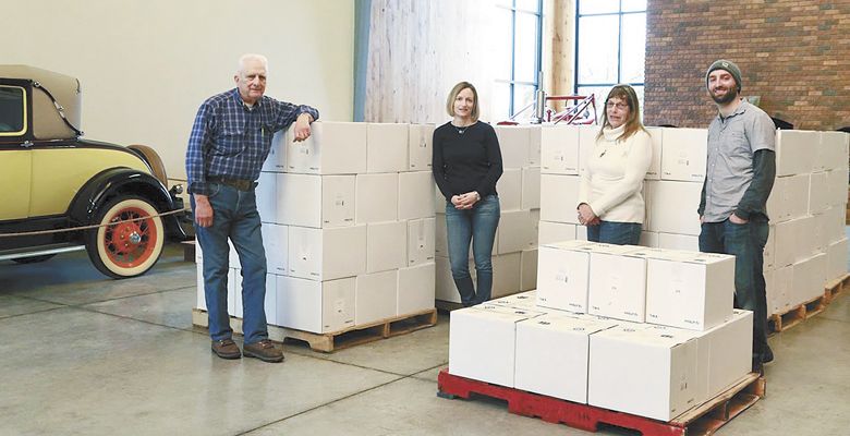 Bob Zielinkski, Tina Millican, Pam Zielinkski and Brian Zielinkski stand among cases of wine at the family’s spacious Scenic Valley Farms tasting room in Salem. ##Photo provided