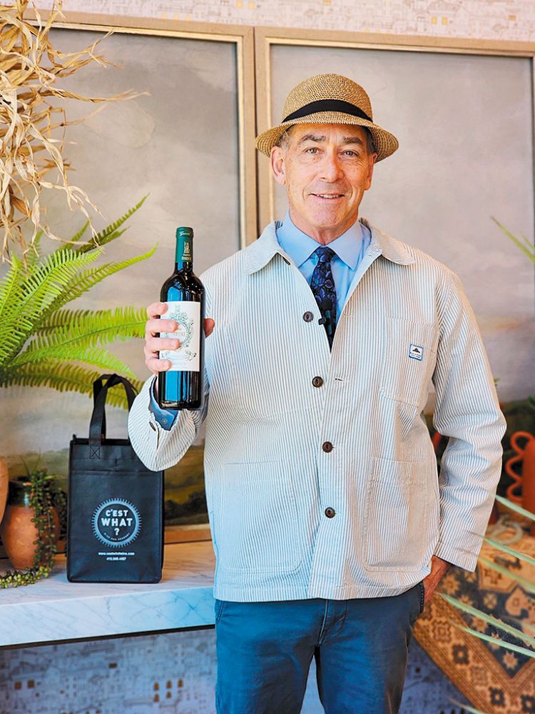 Sommelier Michael Perman holding a bottle of wine. ## Photo provided by C’est What?