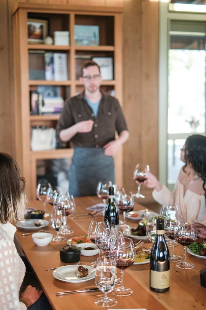 Chef Clayton Allen talking with guests at Soter Vineyards. ##Photo by Josh Chang