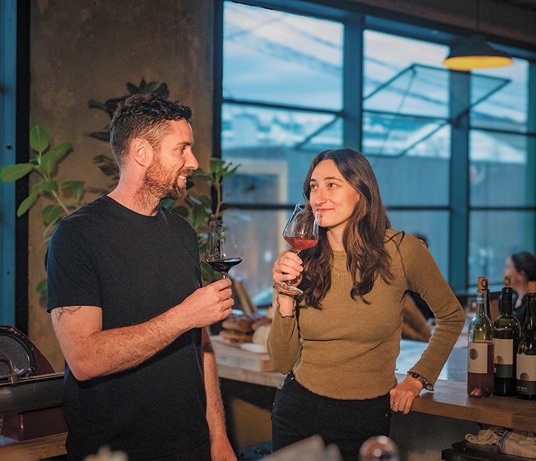 Graham Markel (left), founder and winemaker of Buona Notte Wines, standing with assistant winemaker Mareka Tsongas. ## Photo by Ron Scott