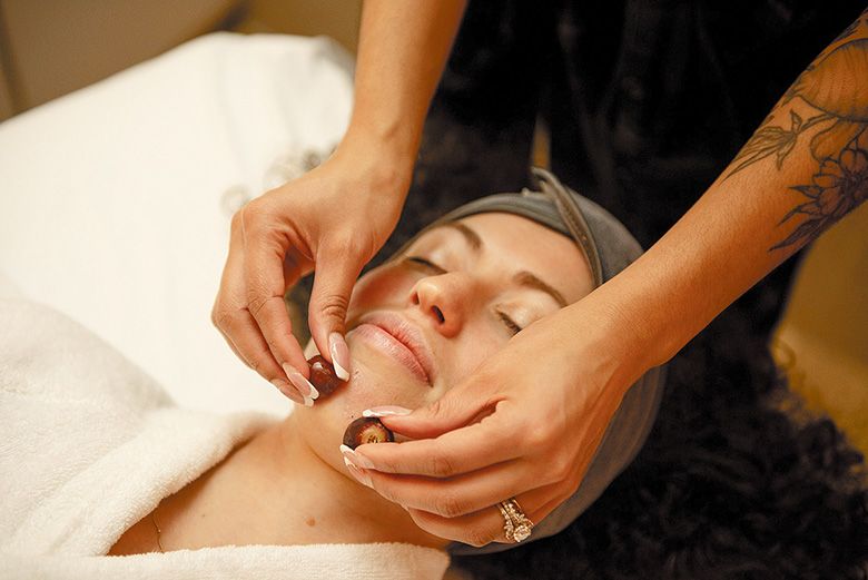 A spa client enjoying a facial using frozen grapes. ## Photo by Kara Cooper