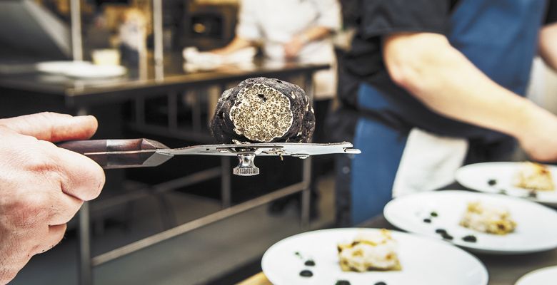 An Oregon black truffle balances on a slicer behind the scenes during the James Beard Legacy Dinner at Domaine Serene. ##Photo by Kathryn Elsesser