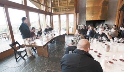 Dick Shea (standing) talks to guests gathered at a comparative tasting event called Tu Shea hosted at Penner-Ash Cellars outside Newberg. (From left) Scott Shull (Raptor Ridge), Lynn Penner-Ash, Stewart Boedecker and Bryan Weil (Alexana) join the discussion and offer their wines made with Shea fruit for the event.