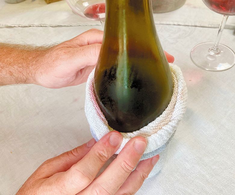 A Cellar Selects panelist pulling a numbered sock off a bottle. ## Photo by Michele Francisco A Cellar Selects panelist pulling a numbered sock off a bottle. ## Photo by Michele Francisco