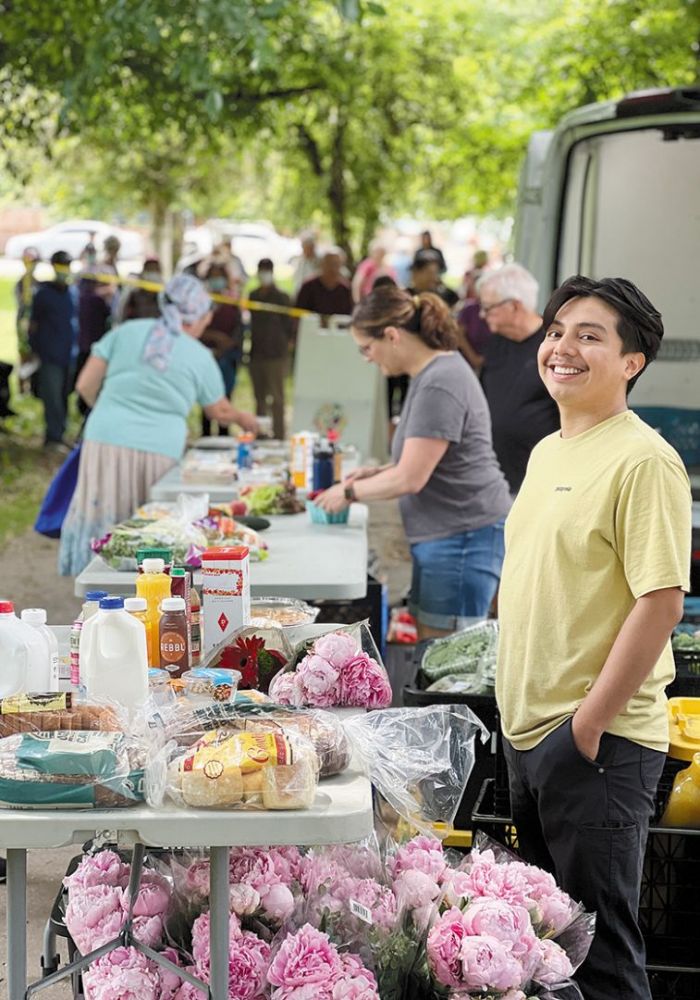 A volunteer standing at a table with donated food items available for free to Urban Gleaners’ shoppers. ## Photo provided by Urban Gleaners A volunteer standing at a table with donated food items available for free to Urban Gleaners’ shoppers. ## Photo provided by Urban Gleaners