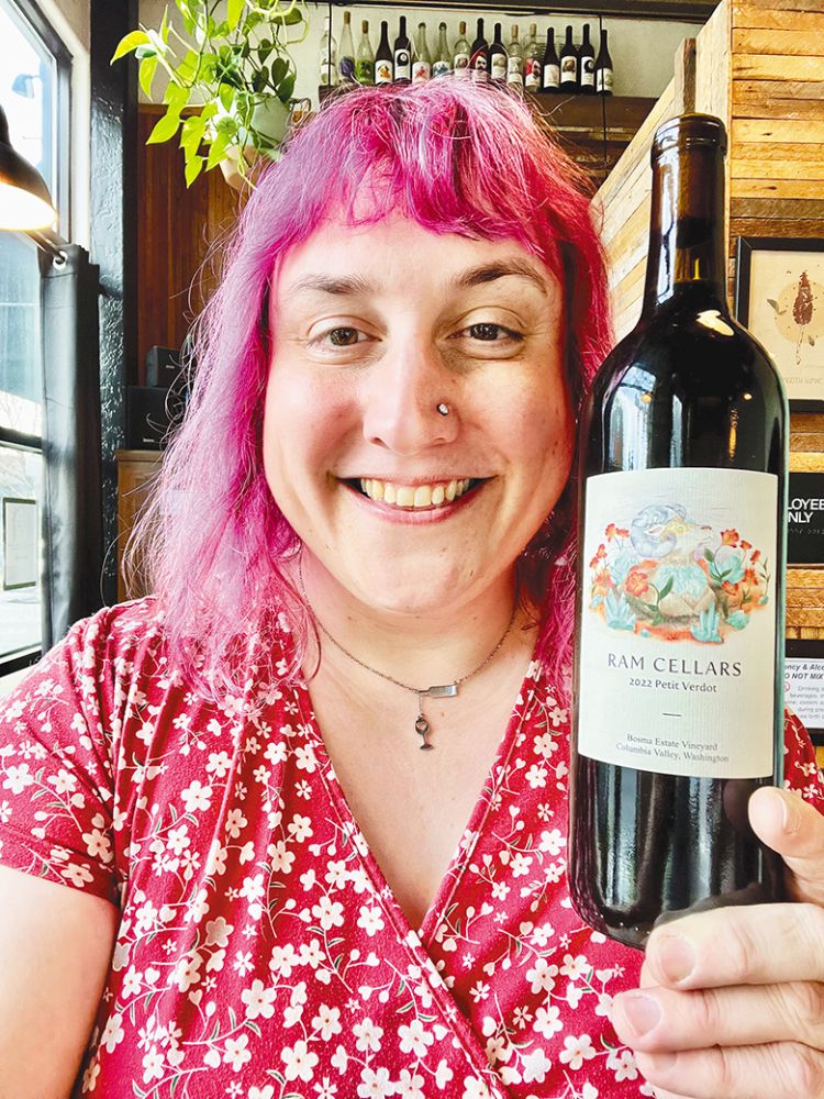 Winemaker Vivianne Kennedy holding a bottle of RAM Cellars wine. ## Photo provided by RAM Cellars