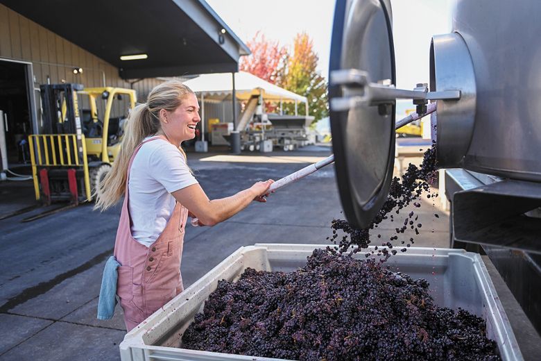 Bergström Wines winemaker, Madeline Rausch, emptying a tank. Bergström Wines winemaker, Madeline Rausch, emptying a tank.