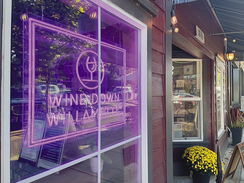 Neon sign in the window of Wine Down Willamette. ## Photo by Greg Norton