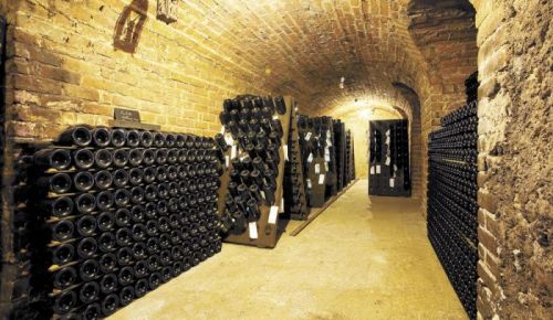 Sparkling fills an old wine cave at a Champagne house in Épernay, France. Stock photo.