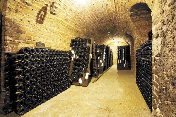 Sparkling fills an old wine cave at a Champagne house in Épernay, France. Stock photo. Sparkling fills an old wine cave at a Champagne house in Épernay, France. Stock photo.