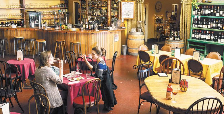 Friends enjoy the ambiance and a glass of wine at Vie de Bohème in Portland. ##Photo by Kathryn Elsesser.