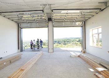 The Shulls roll open the doors to the new Raptor Ridge facility. Photo by Marcus Larson.