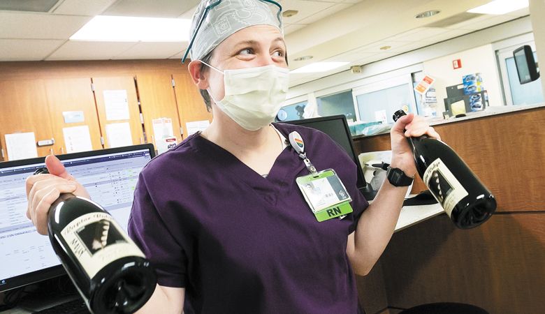 An appreciative nurse pauses from her work to say thank you to participating wineries. ##Photo provided