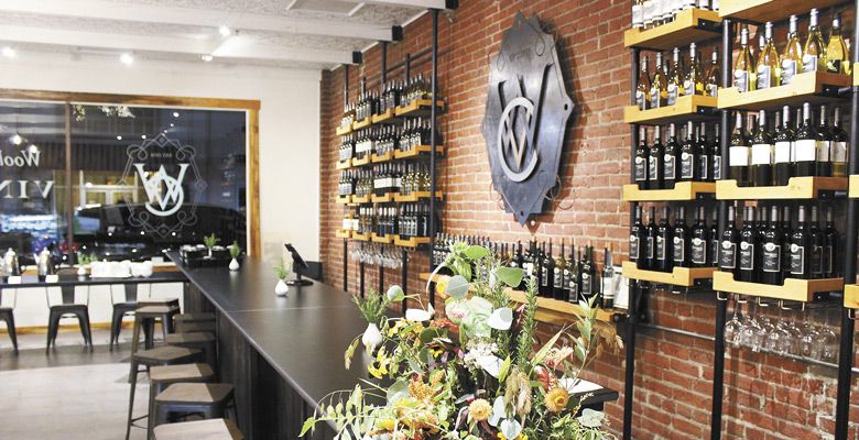 A long, sleek bar stands in front of a wall of Wooldridge Creek wines at Vinfarm. ##Photo by Maureen Battistella