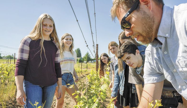 Jared Collins instructs Briley Ingram (from left), Chloe Warren, Layla Knight, Olivia Davison, Kaydence Vertner and Nole Lawson in the Tiger Vines Vineyard.##Photo by Brett Curtis