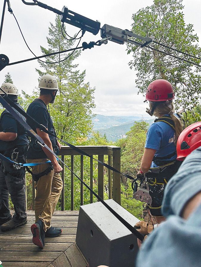 People preparing to zipline down the Rogue Valley ZipLine Adventures course. ## Photo provided by Rogue Valley ZipLine Adventures