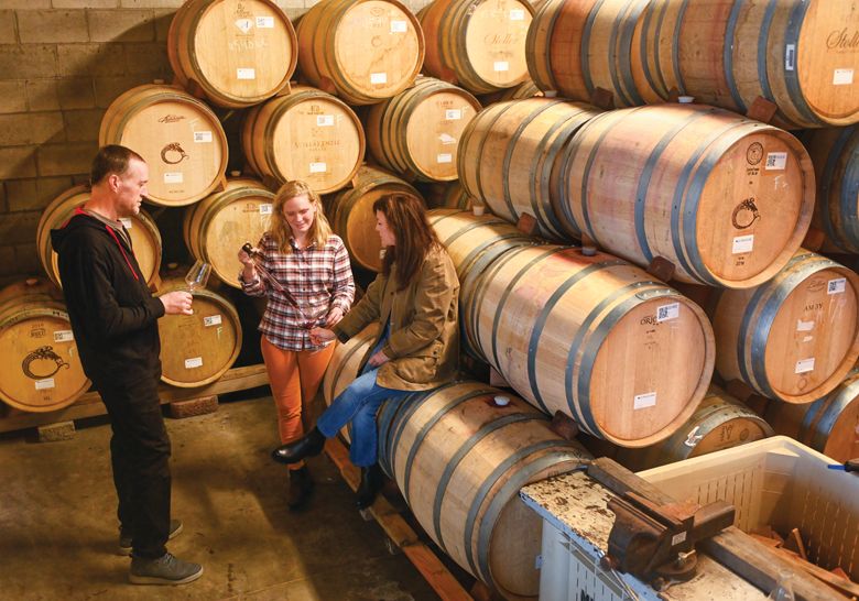 Brooks tasting samples from barrel with winemaker Chris Williams (left) and associate winemaker Claire Jarreau.