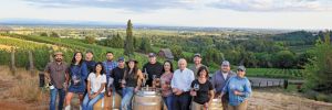 Members and graduates of the pEr From left; Miguel Lopez, AHIVOY co- founder, Red Dirt Vineyard Management and Wine Making; DeAnna Ornelas, AHIVOY president, Winderlea Vineyard and Winery tasting room and hospitality manager; Hector Cabrera, AHIVOY graduate, Argyle Winery equipment supervisor; Elena Rodriguez, AHIVOY Board of Directors, Alumbra Cellars president and winemaker; Adrian Mendoza, AHIVOY graduate, Northwest Wine Company vineyard supervisor, Alad Vineyard owner; Ivan George, AHIVOY graduate, Vitis Terra Vineyard Services assistant vineyard manager; Sofia Torres McKay, AHIVOY co-founder, Cramoisi Vineyard owner and winegrower; Sam Parra, AHIVOY co-chair, Parra Wine Co. proprietor;  Sonia Nieto Solano, AHIVOY graduate, Results Partners vineyard manager; Neal D. Hulkower, AHIVOY Board of Directors; Bryan Berenguer, AHIVOY Board of Directors, Human Cellars winemaker, Chemeketa Community College vineyard management instructor; Cristina Gonzales, AHIVOY secretary, Gonzales Wine Company winemaker and founder; Fermin Valdovinos, AHIVOY graduate, Four Diamonds vineyard supervisor and maintenance; Elizabeth Sánchez, AHIVOY graduate, Four Diamonds vineyard maintenance; plus Lava girl, Cramoisi Vineyard tasting room greeter and vineyard dog.