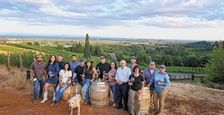 Members and graduates of the pEr From left; Miguel Lopez, AHIVOY co- founder, Red Dirt Vineyard Management and Wine Making; DeAnna Ornelas, AHIVOY president, Winderlea Vineyard and Winery tasting room and hospitality manager; Hector Cabrera, AHIVOY graduate, Argyle Winery equipment supervisor; Elena Rodriguez, AHIVOY Board of Directors, Alumbra Cellars president and winemaker; Adrian Mendoza, AHIVOY graduate, Northwest Wine Company vineyard supervisor, Alad Vineyard owner; Ivan George, AHIVOY graduate, Vitis Terra Vineyard Services assistant vineyard manager; Sofia Torres McKay, AHIVOY co-founder, Cramoisi Vineyard owner and winegrower; Sam Parra, AHIVOY co-chair, Parra Wine Co. proprietor;  Sonia Nieto Solano, AHIVOY graduate, Results Partners vineyard manager; Neal D. Hulkower, AHIVOY Board of Directors; Bryan Berenguer, AHIVOY Board of Directors, Human Cellars winemaker, Chemeketa Community College vineyard management instructor; Cristina Gonzales, AHIVOY secretary, Gonzales Wine Company winemaker and founder; Fermin Valdovinos, AHIVOY graduate, Four Diamonds vineyard supervisor and maintenance; Elizabeth Sánchez, AHIVOY graduate, Four Diamonds vineyard maintenance; plus Lava girl, Cramoisi Vineyard tasting room greeter and vineyard dog.
