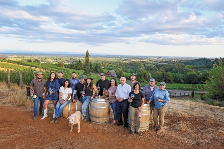 Members and graduates of the pEr From left; Miguel Lopez, AHIVOY co- founder, Red Dirt Vineyard Management and Wine Making; DeAnna Ornelas, AHIVOY president, Winderlea Vineyard and Winery tasting room and hospitality manager; Hector Cabrera, AHIVOY graduate, Argyle Winery equipment supervisor; Elena Rodriguez, AHIVOY Board of Directors, Alumbra Cellars president and winemaker; Adrian Mendoza, AHIVOY graduate, Northwest Wine Company vineyard supervisor, Alad Vineyard owner; Ivan George, AHIVOY graduate, Vitis Terra Vineyard Services assistant vineyard manager; Sofia Torres McKay, AHIVOY co-founder, Cramoisi Vineyard owner and winegrower; Sam Parra, AHIVOY co-chair, Parra Wine Co. proprietor;  Sonia Nieto Solano, AHIVOY graduate, Results Partners vineyard manager; Neal D. Hulkower, AHIVOY Board of Directors; Bryan Berenguer, AHIVOY Board of Directors, Human Cellars winemaker, Chemeketa Community College vineyard management instructor; Cristina Gonzales, AHIVOY secretary, Gonzales Wine Company winemaker and founder; Fermin Valdovinos, AHIVOY graduate, Four Diamonds vineyard supervisor and maintenance; Elizabeth Sánchez, AHIVOY graduate, Four Diamonds vineyard maintenance; plus Lava girl, Cramoisi Vineyard tasting room greeter and vineyard dog.